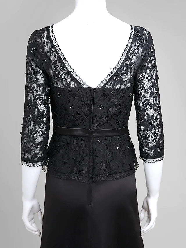Woman in a dark blue A-line V-neck half-sleeve lace satin dress, posing gracefully.