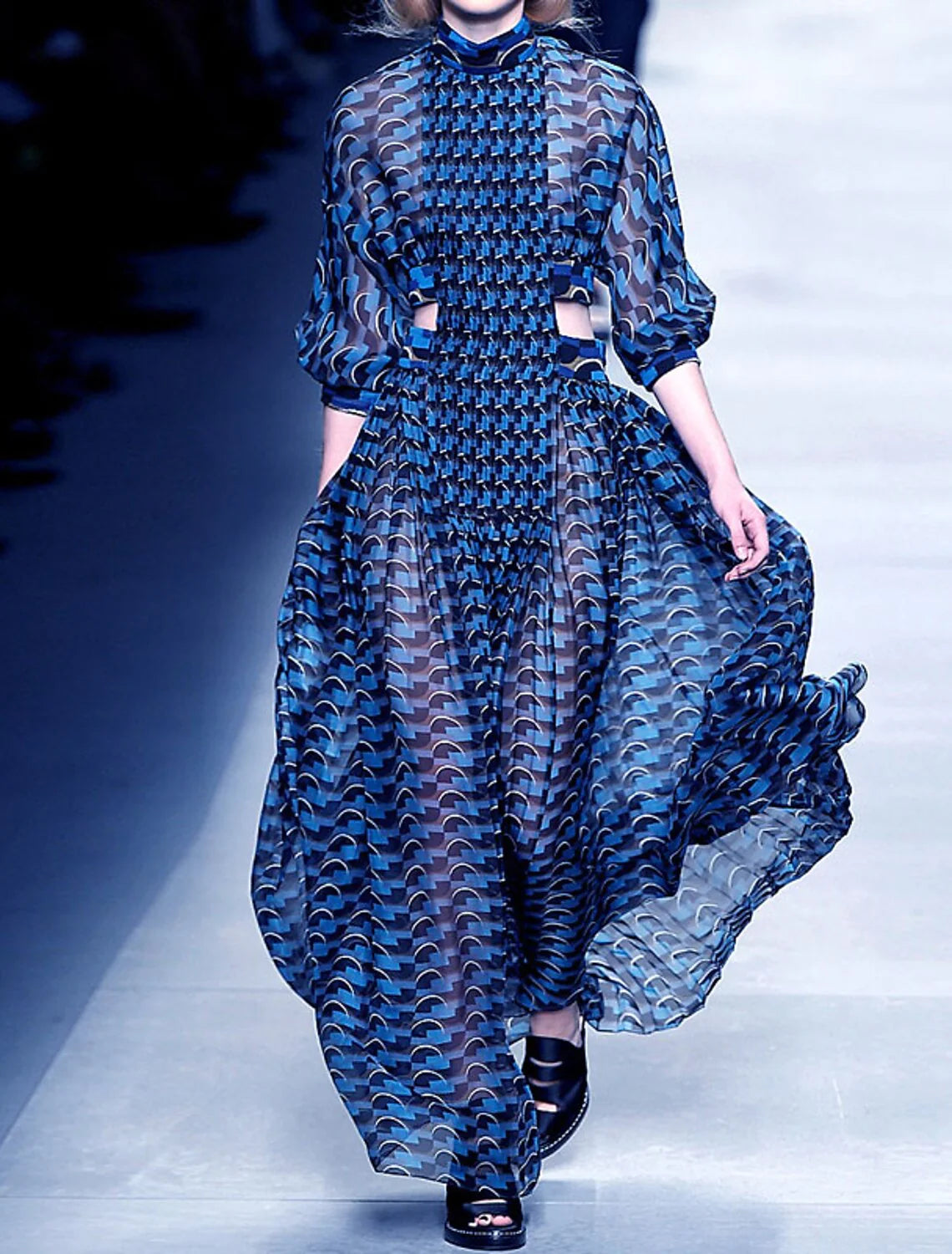 Back view of woman in high neck long sleeve floral print dress.