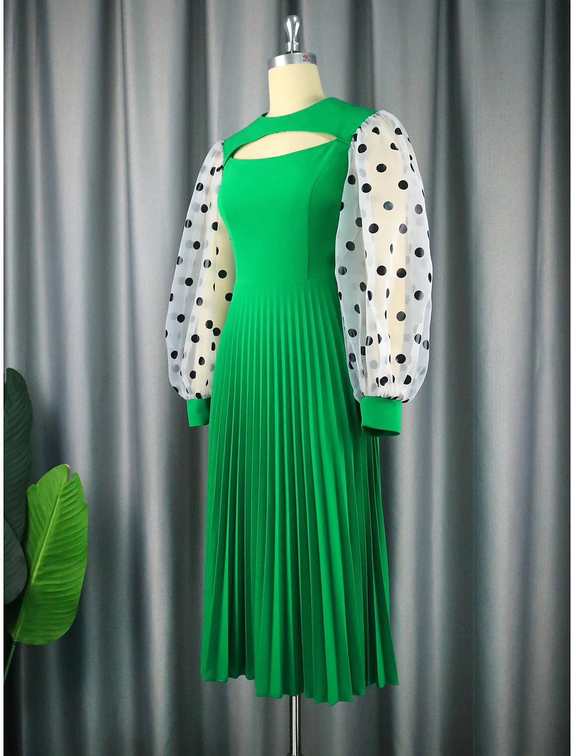Back view of the A-line tea-length dress, showcasing the chiffon fabric and elegant silhouette.