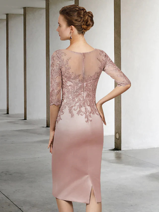 Close-up of delicate lace and applique details on the dark blue dress sleeve.