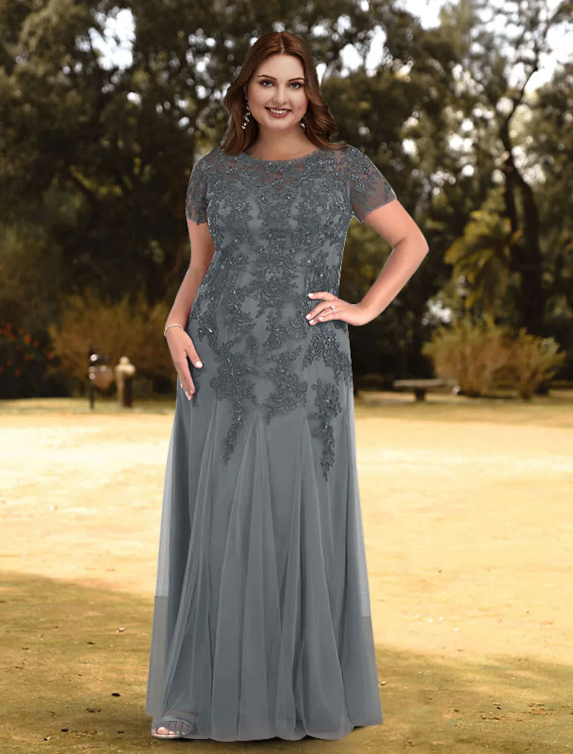 Back view of a woman wearing an elegant A-line jewel neck short sleeve lace pleated floor-length evening gown.