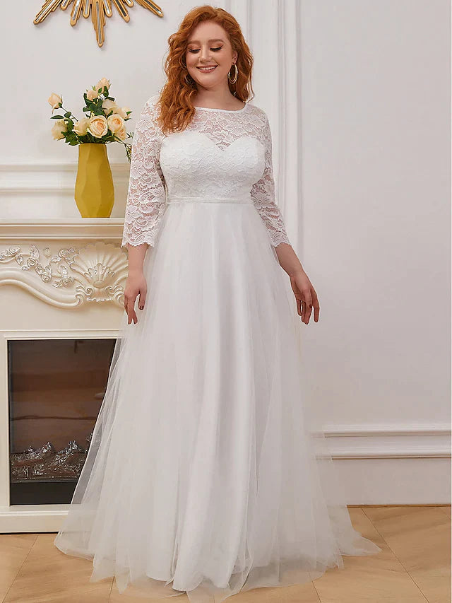 Side profile of a plus size bride in the elegant white lace wedding dress.