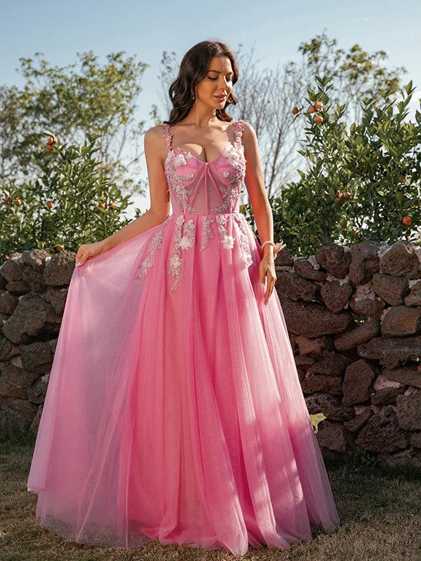 Close-up of the intricate tulle applique and strap details on the dress bodice.