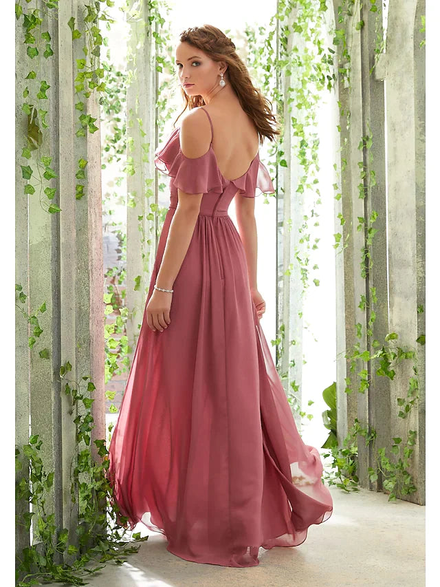 Woman posing in a floor-length chiffon bridesmaid dress, showcasing the open back and ruched details.