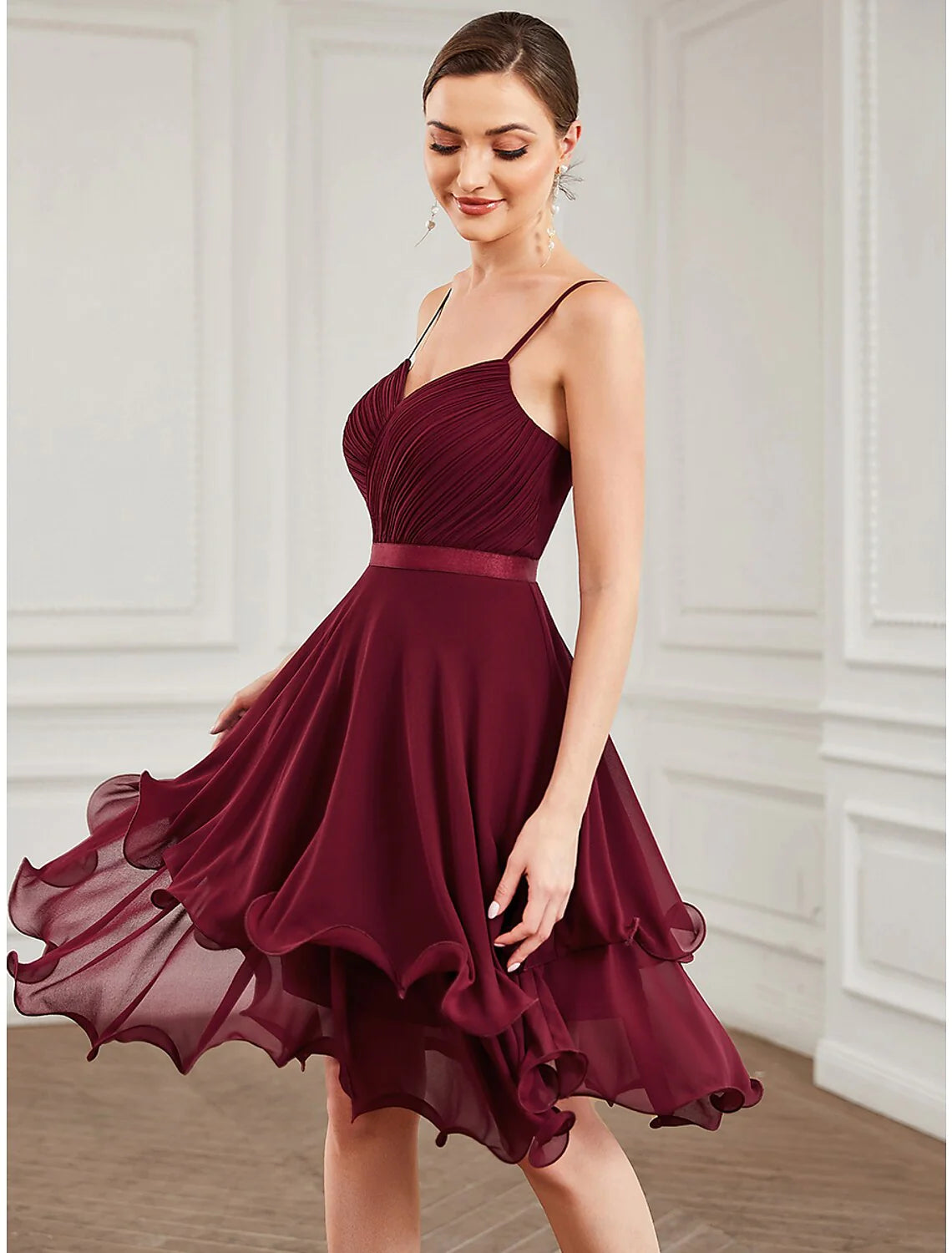 Close-up of the tiered chiffon fabric and sweetheart neckline on a pure color A-line homecoming dress.