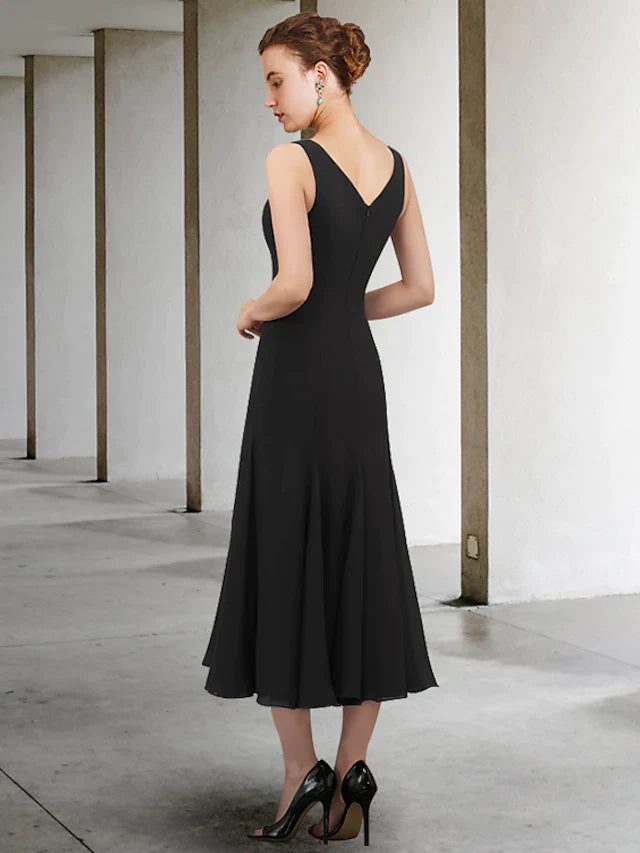 Close-up of the V-neck and beaded details on the A-line chiffon dress.