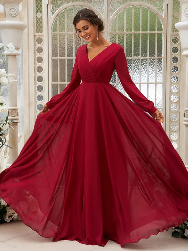 Model posing in a flowing light blue A-line floor-length bridesmaid gown.