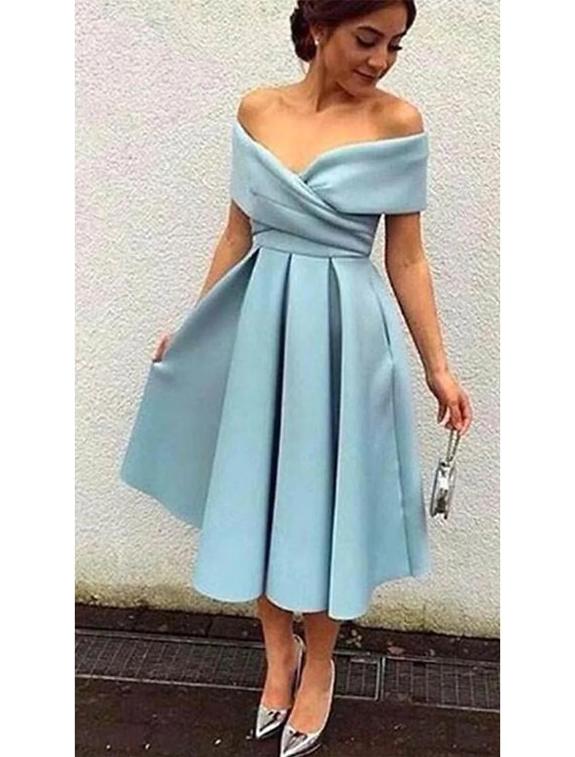 Woman in a purple A-line V-neck short sleeve dress, captured from a side profile.