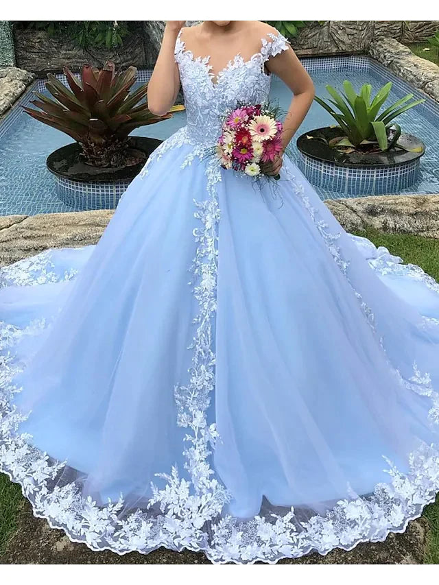 Side profile of a bride in the elegant ball gown wedding dress, highlighting its silhouette and appliques.