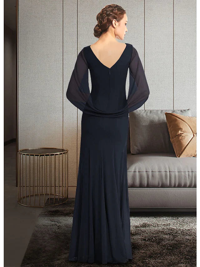 Woman posing in an elegant jewel neck, half-sleeve, ankle-length chiffon Mother of the Bride dress with pleats and ruching.