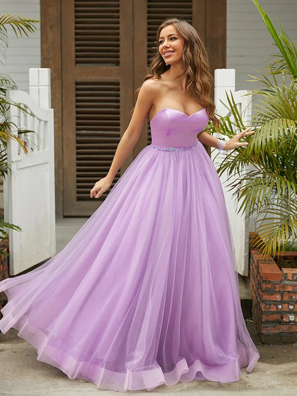 Model wearing a light blue A-line sweetheart prom dress, full length.