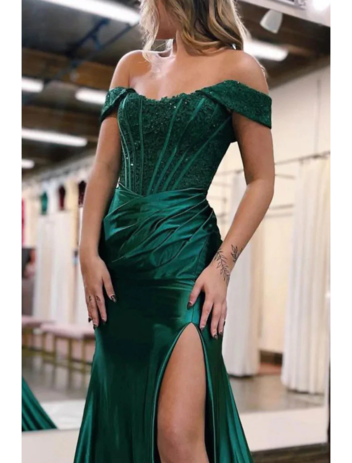 Back view of the off-shoulder mermaid trumpet gown, showcasing the court train and fitted silhouette.