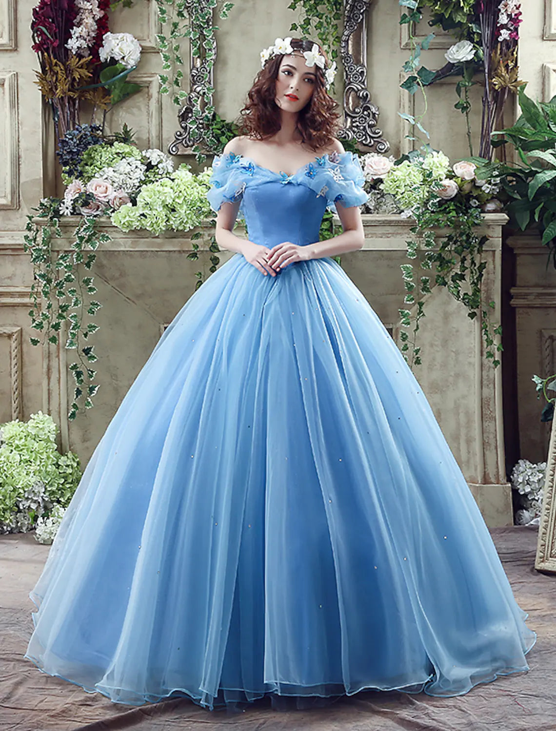 Light blue off-shoulder satin ball gown with short sleeves, intricate appliques, and a chapel train.