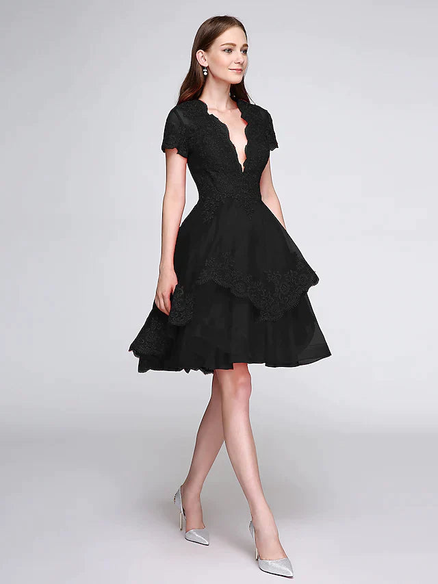 Detailed shot of the plunging neckline and delicate lace appliques on the front of the elegant dress.