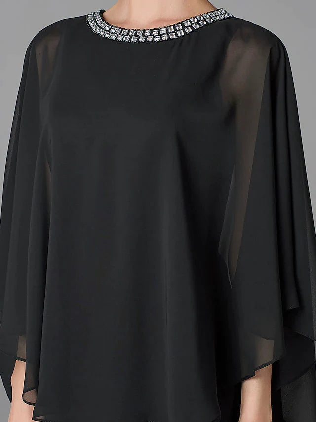 Close-up of the jewel neck and beaded details on the elegant dress.
