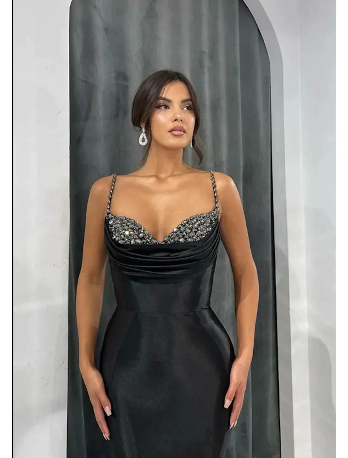 Back view of the glamorous mermaid trumpet evening gown, showcasing the open back and court train.