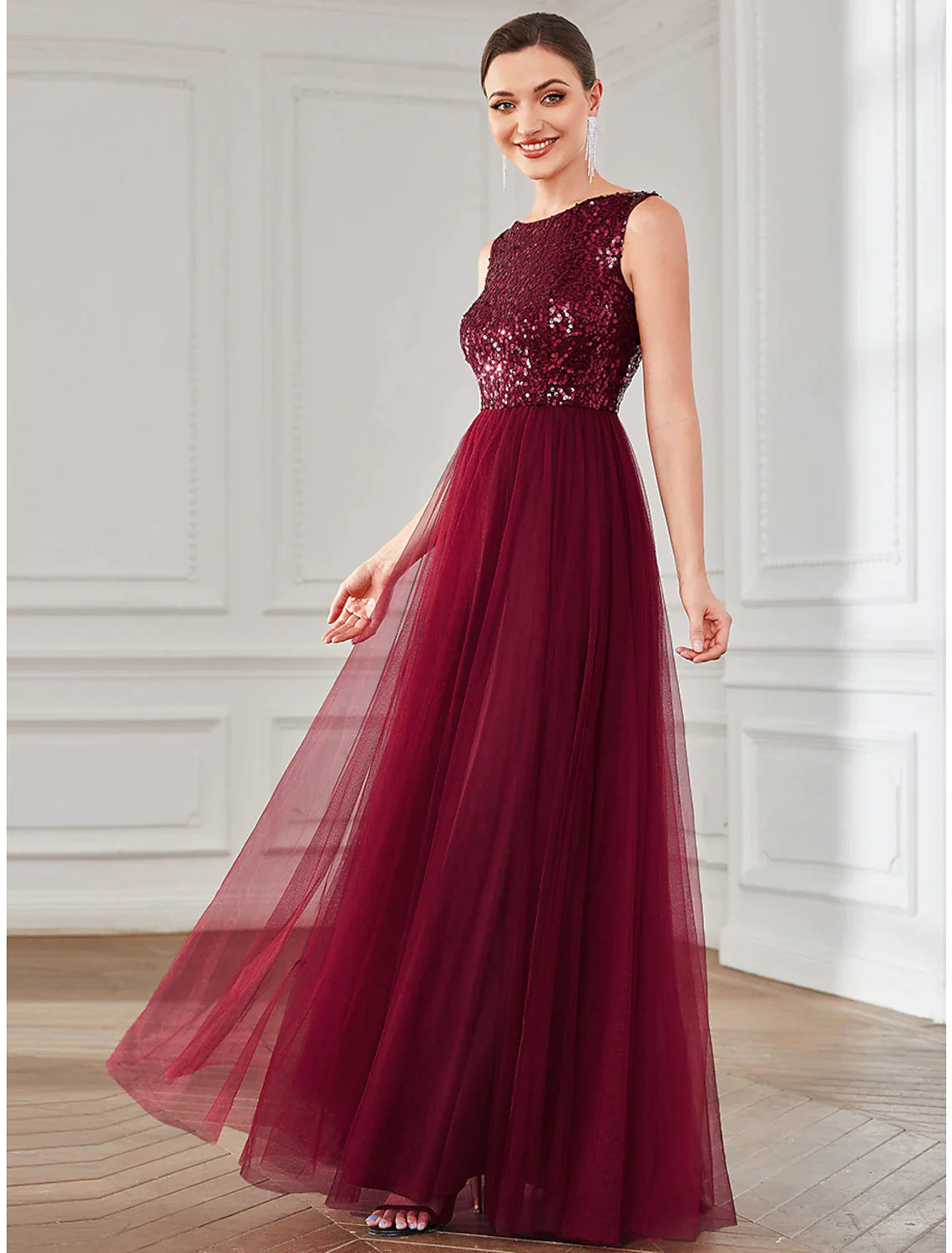 Model posing in the shimmering A-line wedding guest dress.