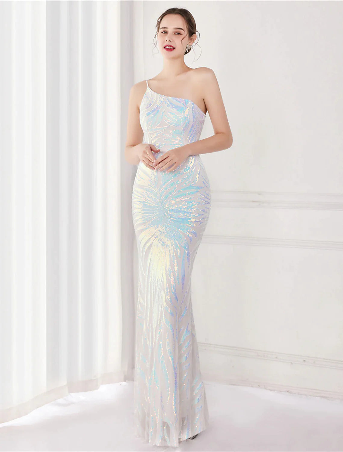 Woman wearing a gold sequined one-shoulder mermaid evening gown.