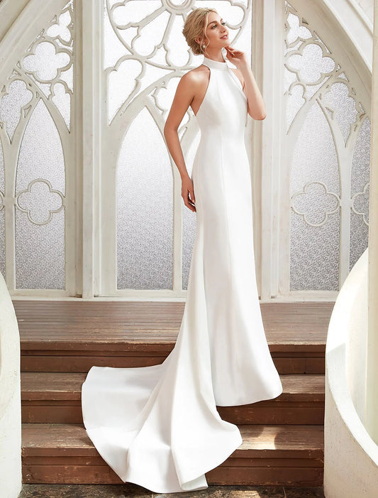 Woman in white halter open back sheath bridal shower dress, front view.