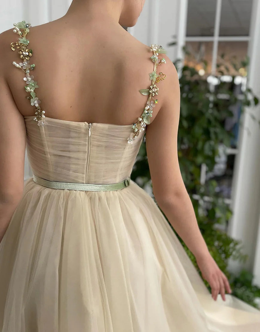 Back view of the apricot A-line tulle homecoming dress, highlighting the delicate tulle fabric.