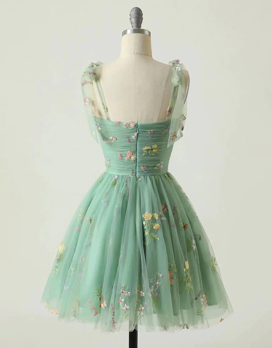 Back view of a short A-line green homecoming dress.