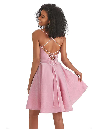 Model in a pink A-line mini dress, highlighting the sequin straps and lurex fabric.