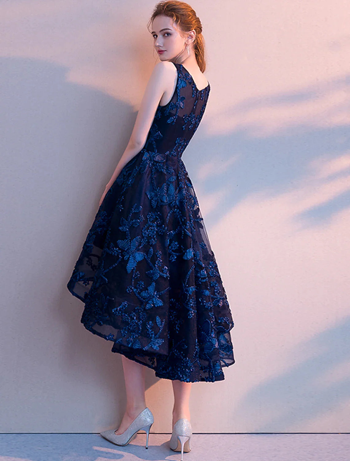Back view of the A-line sleeveless cocktail dress showing pleated tulle fabric.