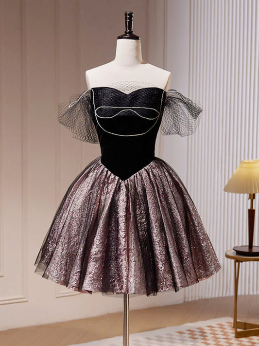 Front view of a model wearing a black off-shoulder A-line tulle short dress.