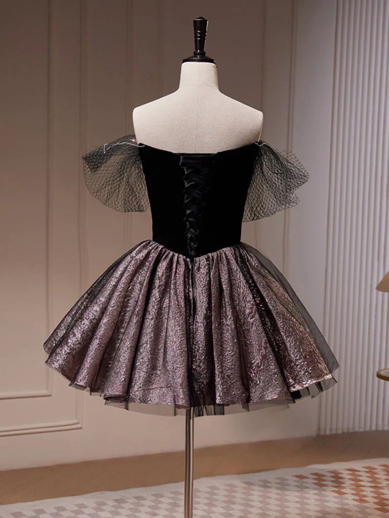 Side view of a model in a black off-shoulder A-line tulle dress.