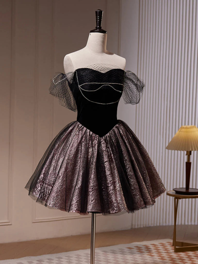 Model posing in a black off-shoulder A-line tulle short dress.