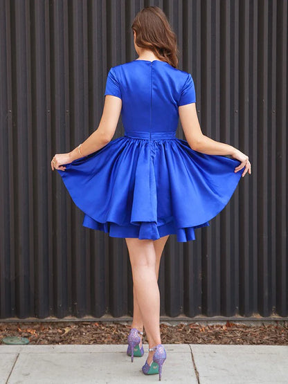 Back view of the A-line satin mini dress with short sleeves and a scoop neckline.