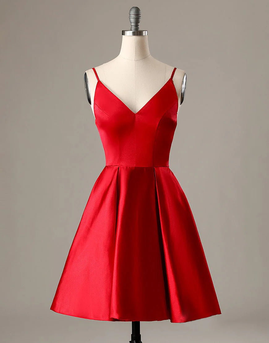 Model wearing a red A-line short homecoming dress with spaghetti straps and pockets.
