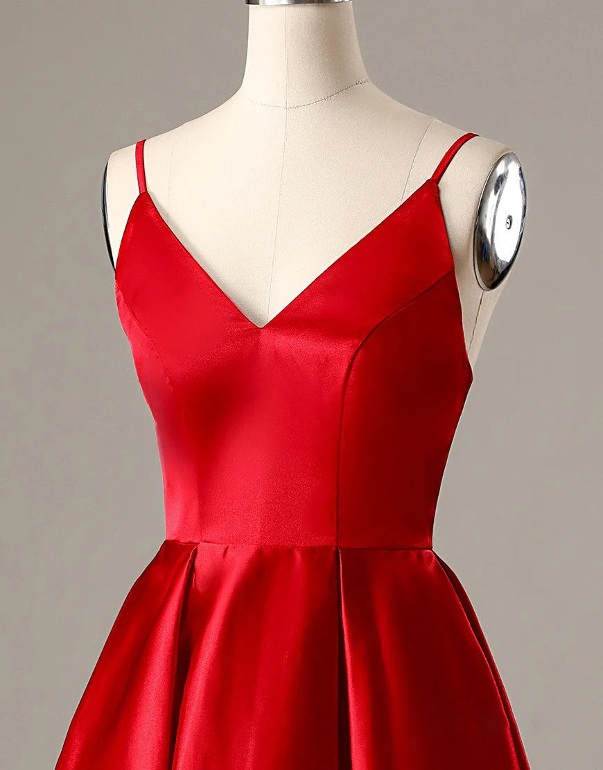 Close-up of the red A-line dress fabric and delicate spaghetti straps.