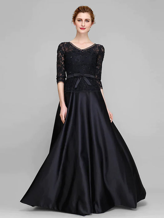 Woman in a dark blue A-line V-neck half-sleeve lace satin dress, front view.