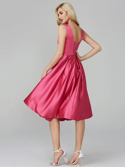 Side view of a model in a navy A-line satin knee-length dress.