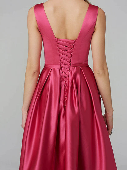 Model in a flowing navy A-line satin dress, showcasing its elegant drape.
