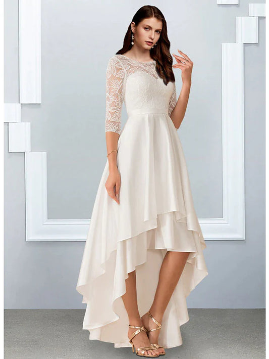 Model wearing an asymmetrical A-line white chiffon dress with half sleeves and ruffles.