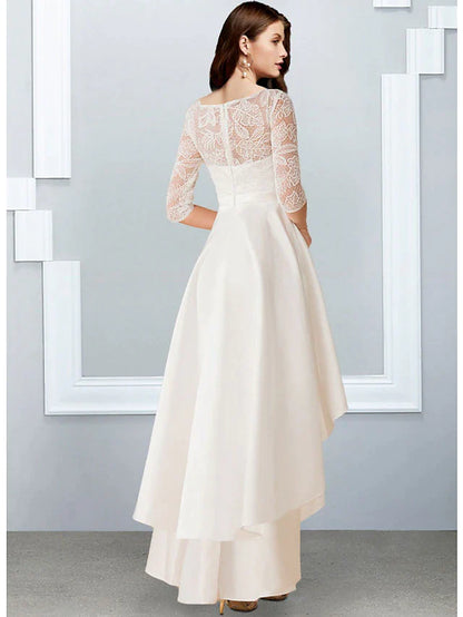 Side view of model in white asymmetrical chiffon dress, highlighting the ruffles.