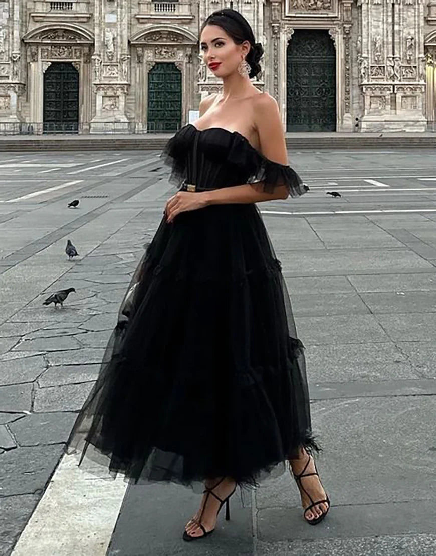 Black off-shoulder A-line tulle homecoming dress, front view.