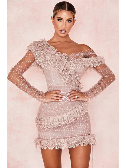 Woman in a black one-shoulder long sleeve mini dress with tulle and lace, perfect for parties.