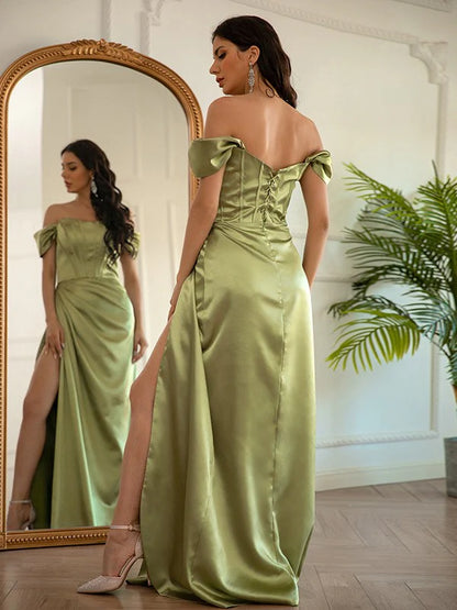 Side view of a rose gold elastic woven satin ruched prom gown.