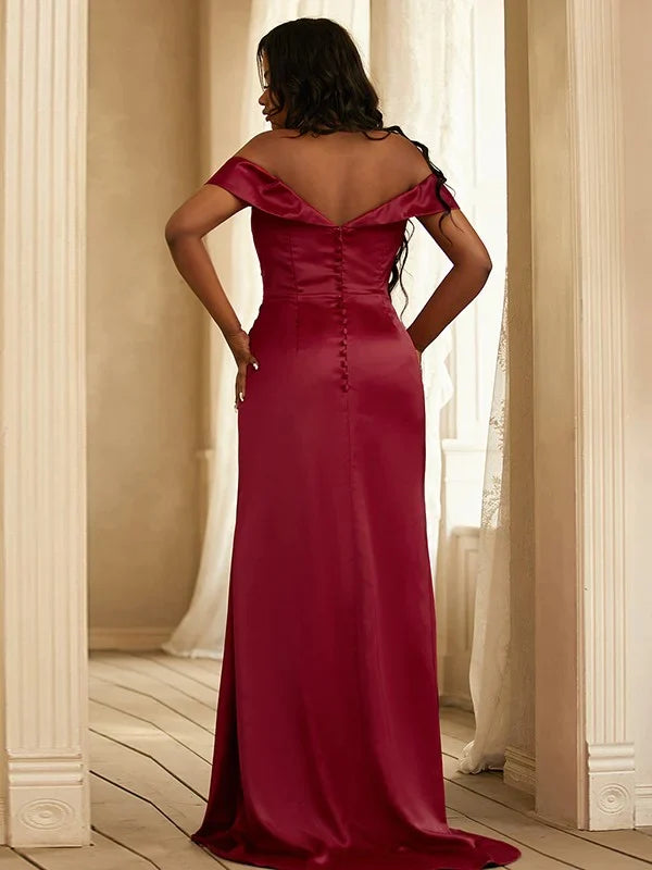 Side view of a flowing red satin ruched A-line bridesmaid gown.