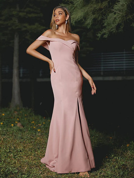 Model wearing a chic stretch crepe off-shoulder bridesmaid dress with ruffles.