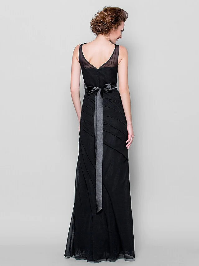 Side view of a woman in a floor-length blue georgette dress with a sash.