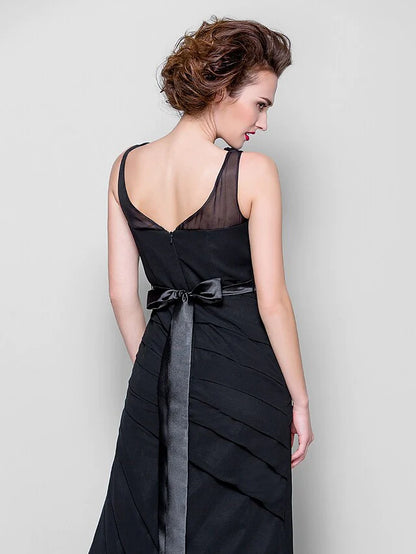Woman posing in the blue Mother of the Bride dress, showcasing its elegant drape.