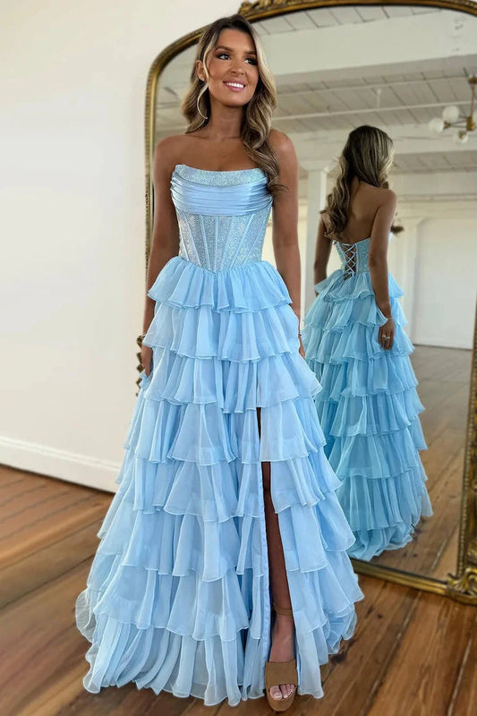 Model posing in a daffodil yellow A-line strapless tiered chiffon long dress.