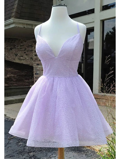 Woman wearing a sparkling A-Line short homecoming dress with spaghetti straps.