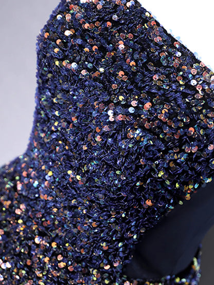 Full length view of a woman wearing a blue strapless sequin dress.