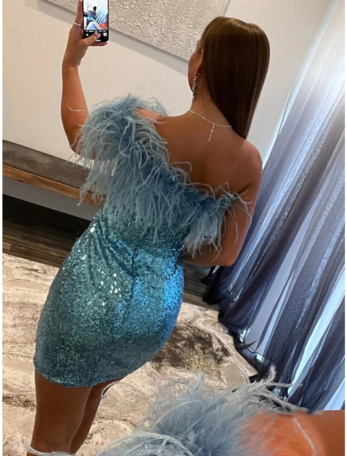 Model posing elegantly in the sequined one-shoulder mermaid cocktail dress.