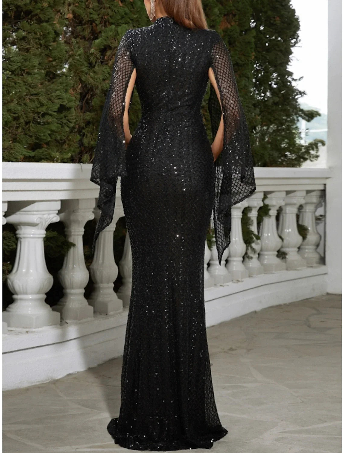 Back view of the sequined mermaid trumpet gown, highlighting the glitter pleats.